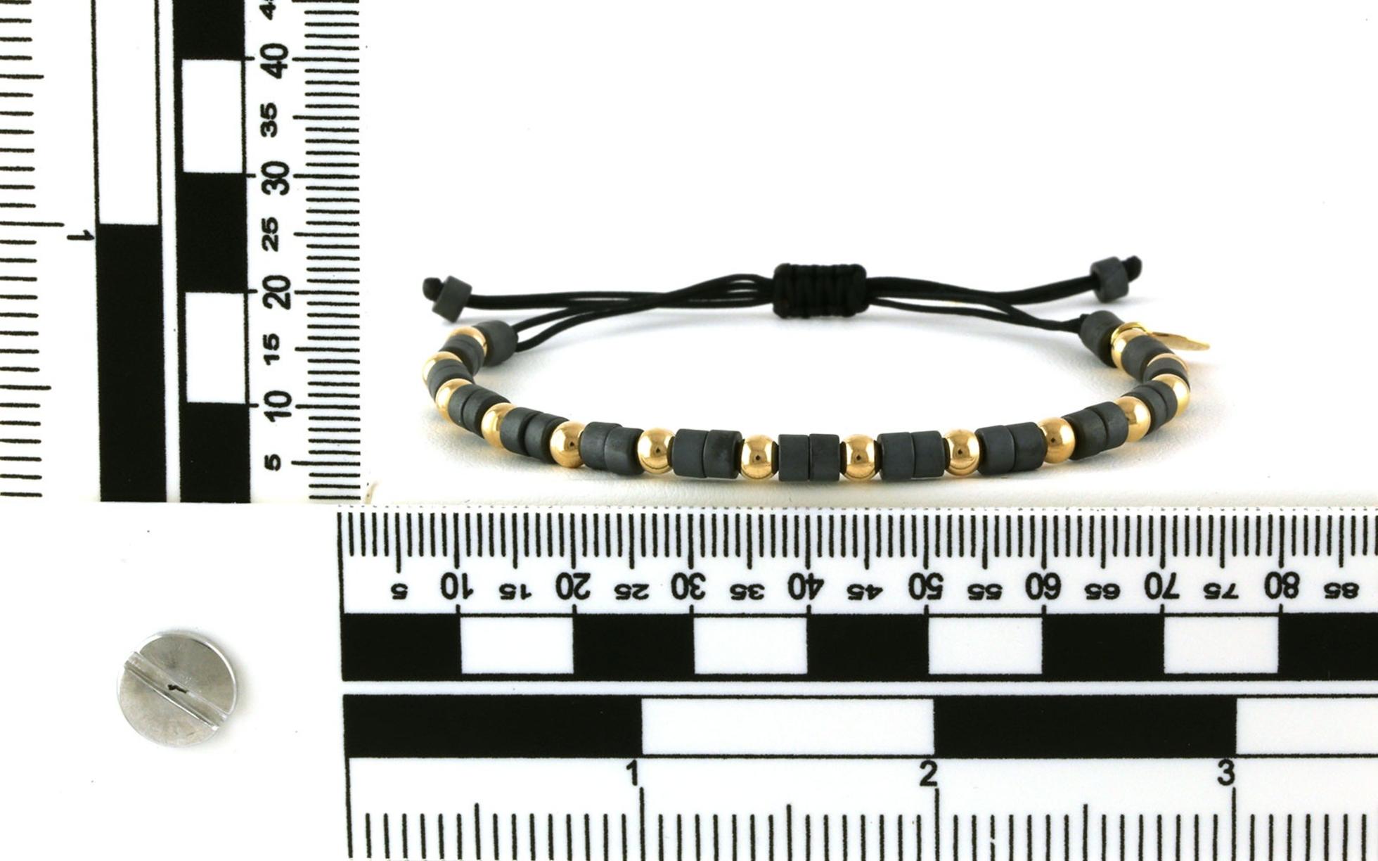 Bolo-style Hematite and Gold Beaded Bracelet on Black Nylon Cord scale