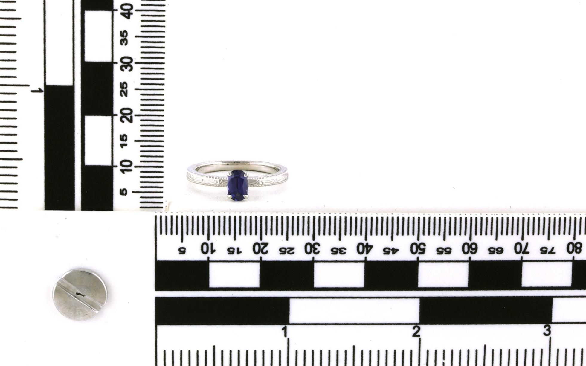 Hidden Halo Oval-cut Huckleberry Sapphire and Diamond Ring with Hand Engraving Details in White Gold (0.54cts) scale