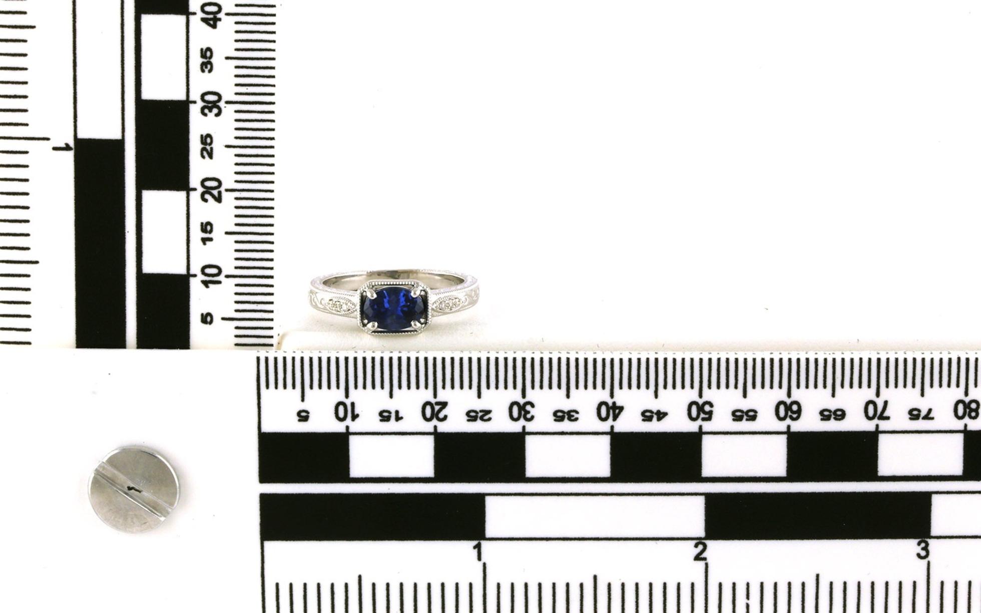 Solitaire-style East-West Oval-cut Montana Sapphire Ring with Hand Engraving and Milgrain Details in White Gold (0.94cts) scale