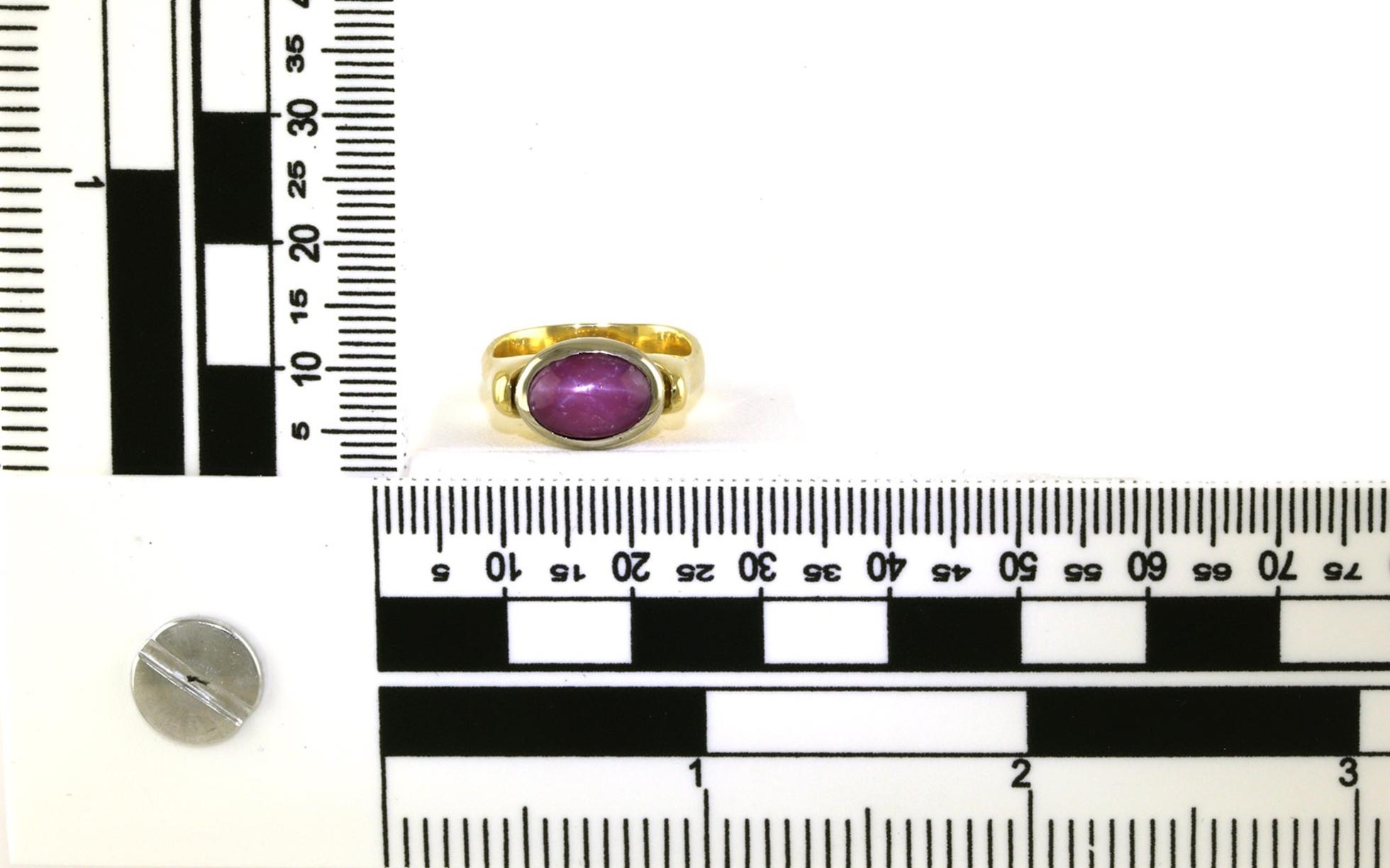 Estate Piece: East-West Bezel-set Oval Cabochon-cut Star Ruby Ring in Two-tone Yellow and White Gold (2.00cts) scale