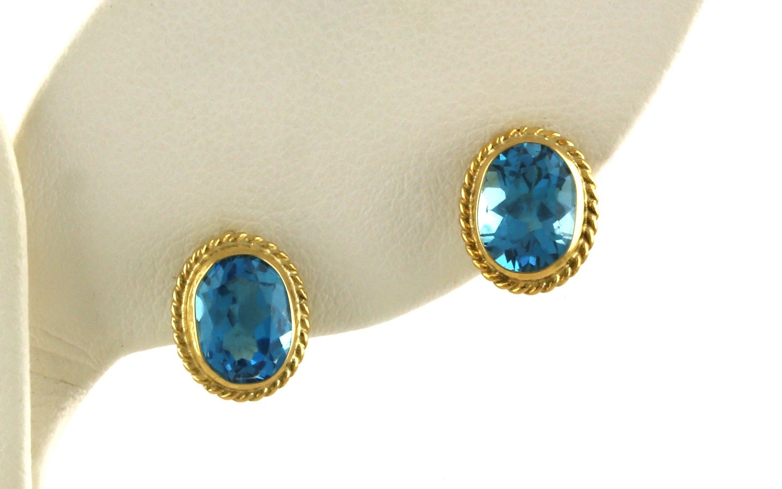 Bezel-set Oval Blue Topaz Stud Earrings with Rope Edge Detail in Yellow Gold