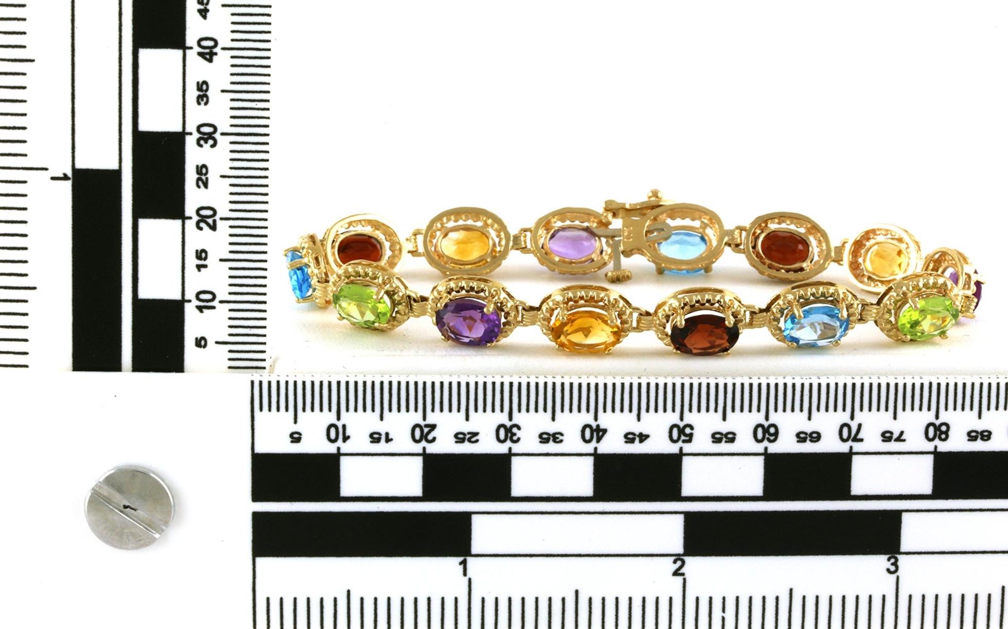 Estate Piece: Rainbow Amethyst, Peridot, Citrine, Blue Topaz, and Garnet Line Bracelet in Yellow Gold scale