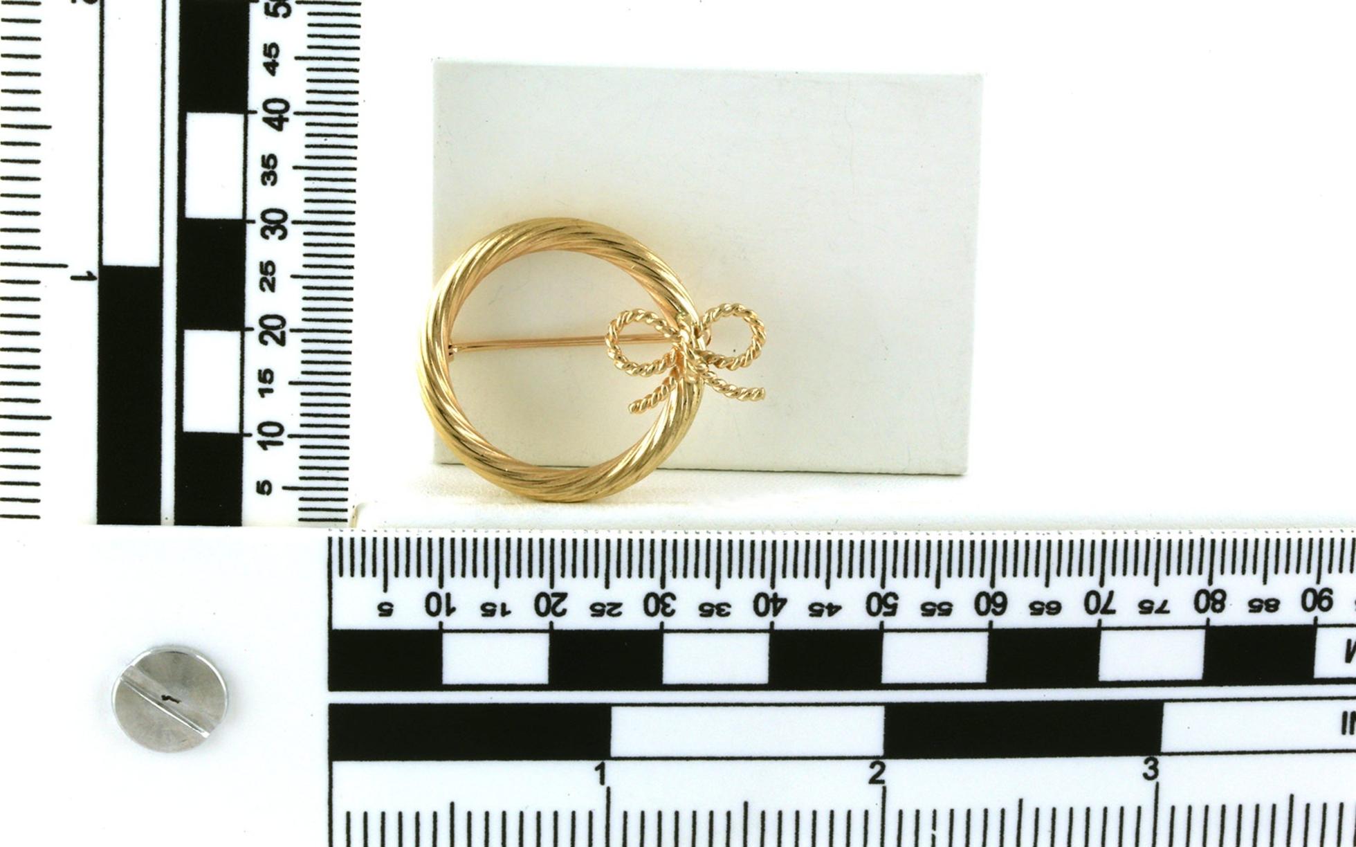 Estate Piece: Tiffany & Co Ribbon Pin in Yellow Gold scale