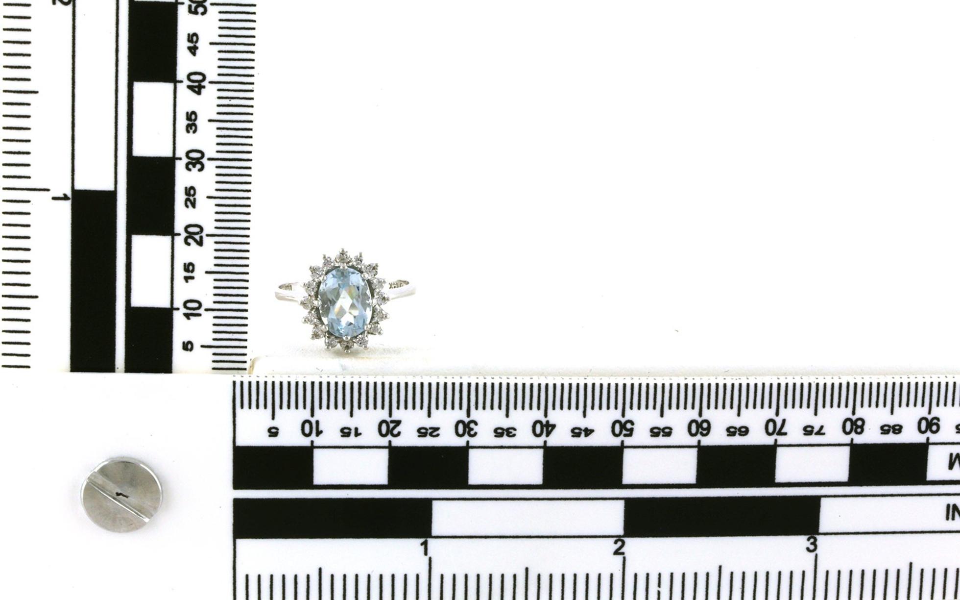 Estate Piece: Oval-cut Aquamarine and Diamond Halo Ring in White Gold (0.20cts TWT) scale