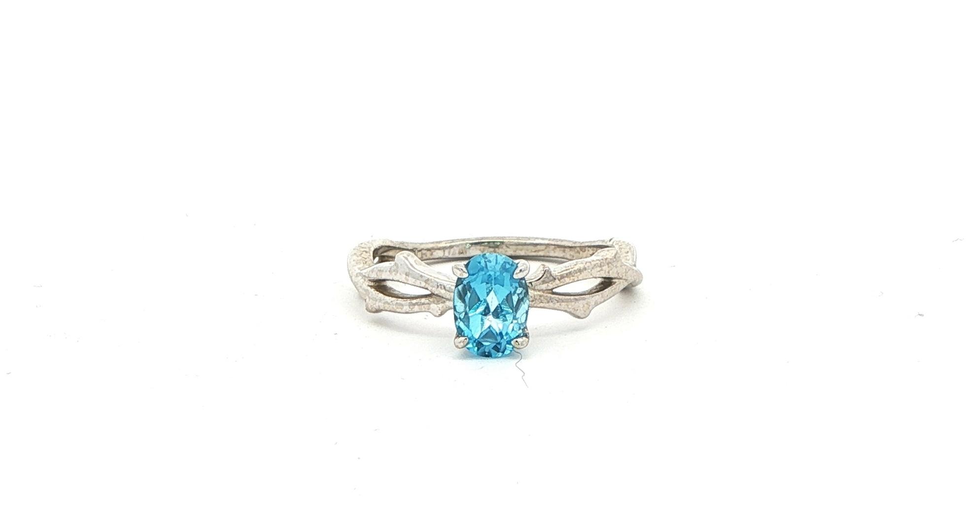 Twining Vines Oval Cut Blue Topaz Solitaire Ring in White Gold