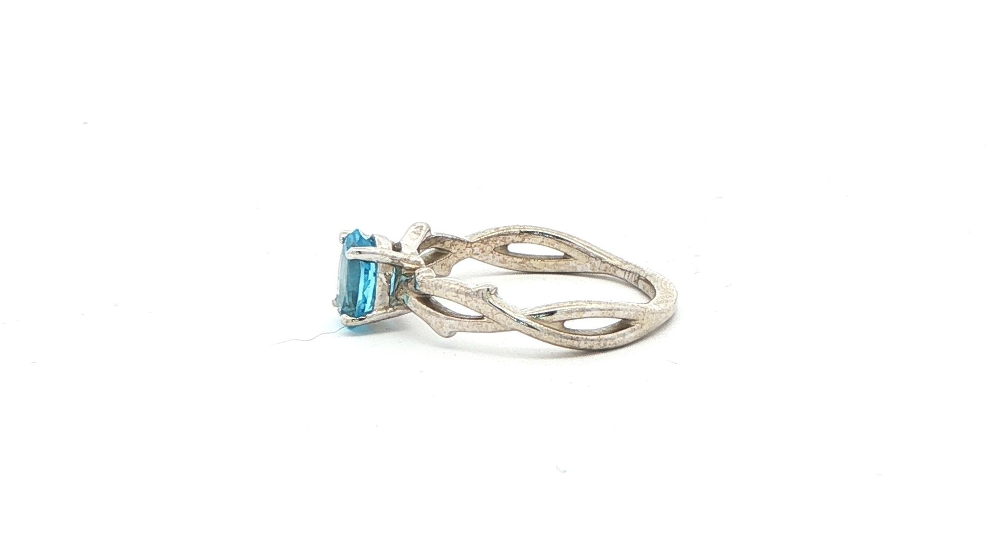 Twining Vines Oval Cut Blue Topaz Solitaire Ring in White Gold side