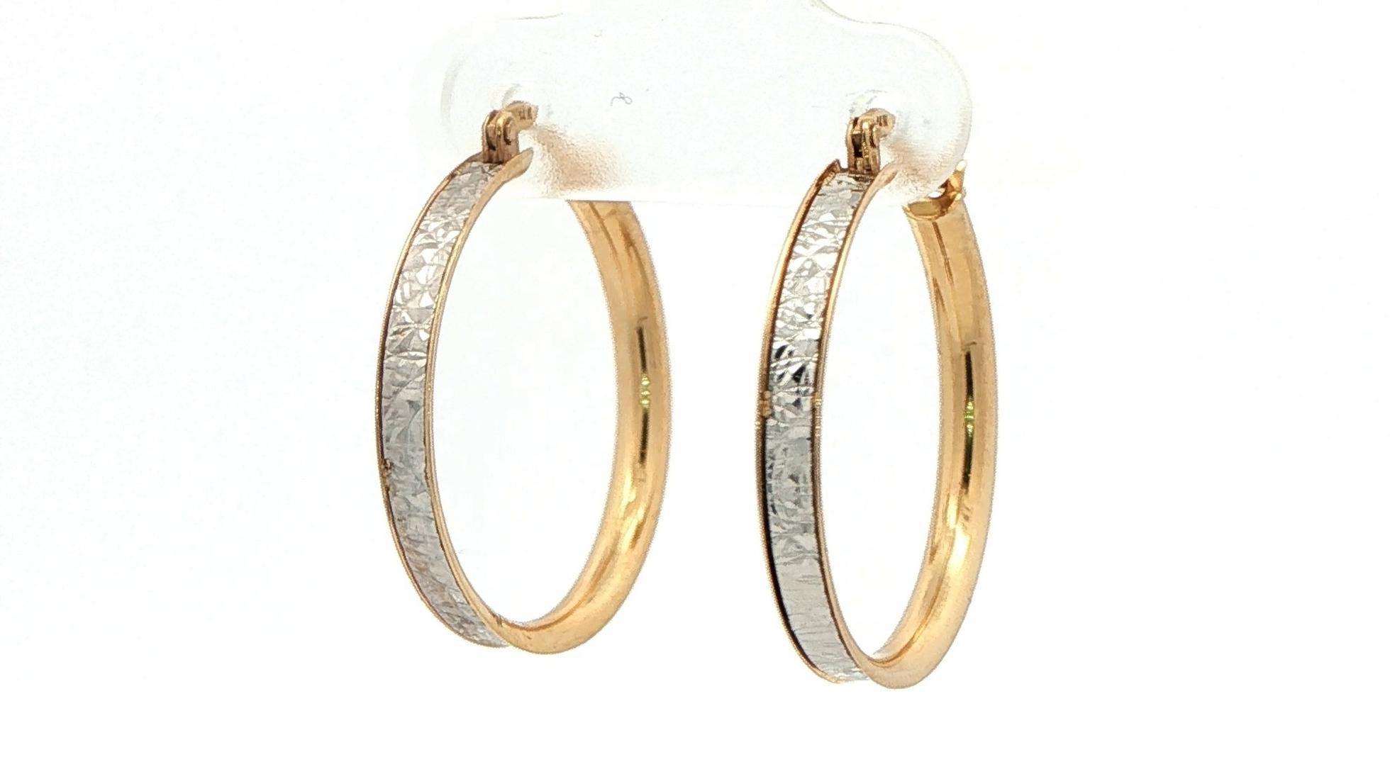 Hoop Earrings in Two-tone Textured White Gold Center and Yellow Gold Edge angled