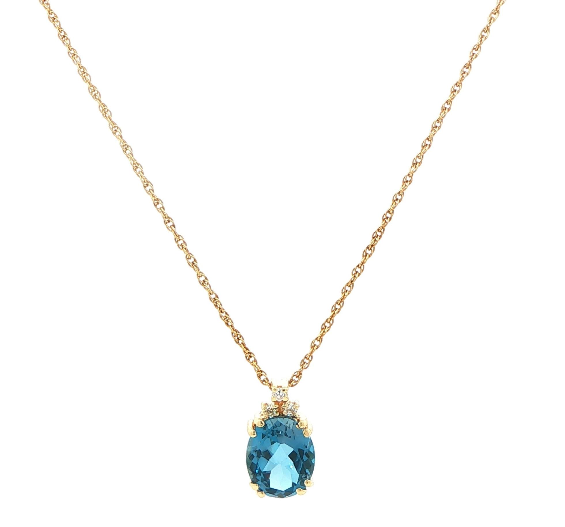 Estate Piece: Oval Blue Topaz and Diamond Accent Pendant Necklace in Yellow Gold