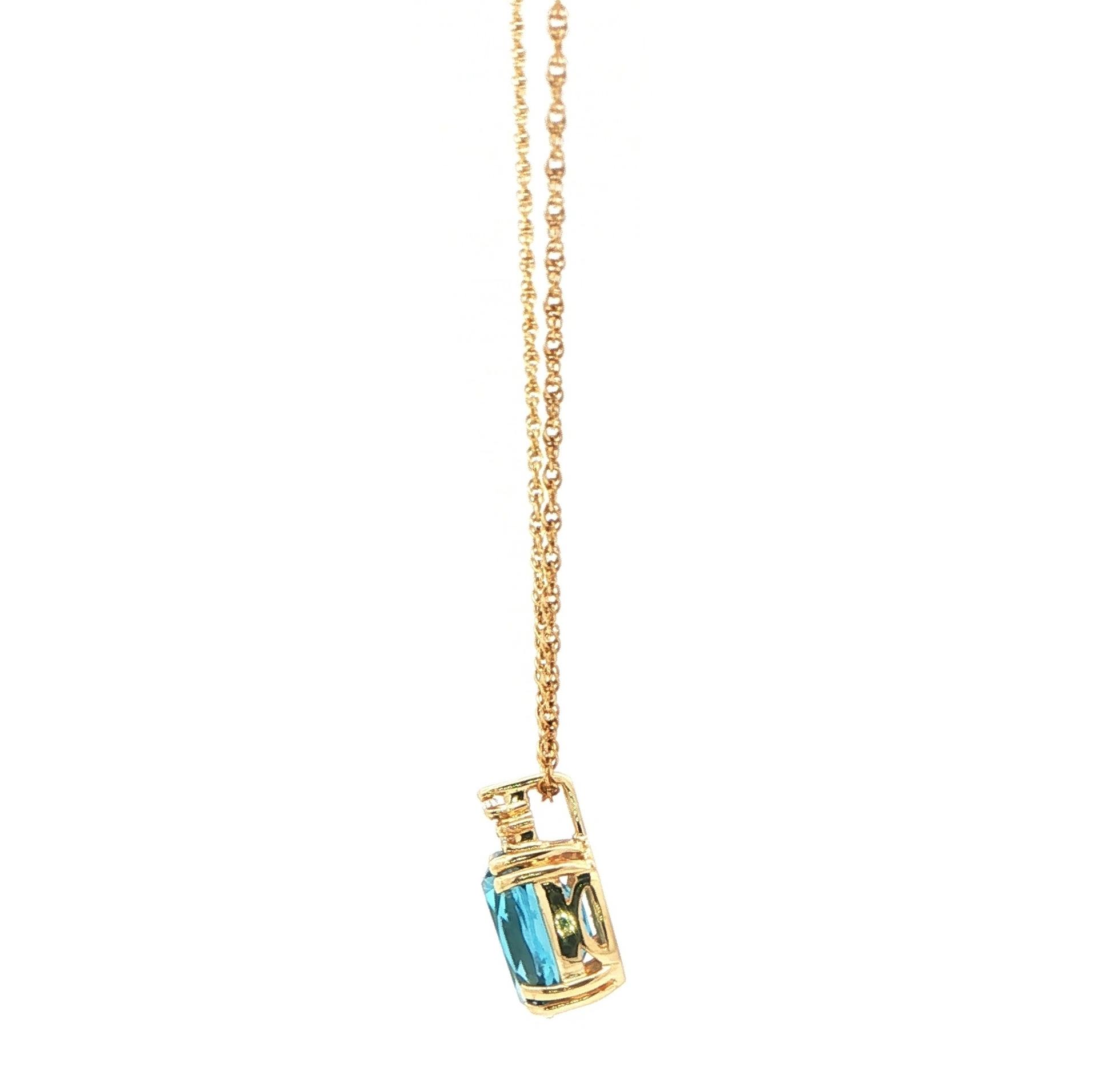 Estate Piece: Oval Blue Topaz and Diamond Accent Pendant Necklace in Yellow Gold side