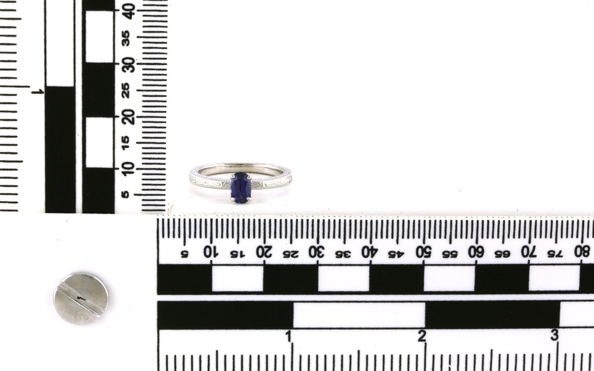 Hand Engraved Oval-cut Huckleberry Sapphire Solitaire Ring in White Gold (0.54ct) scale