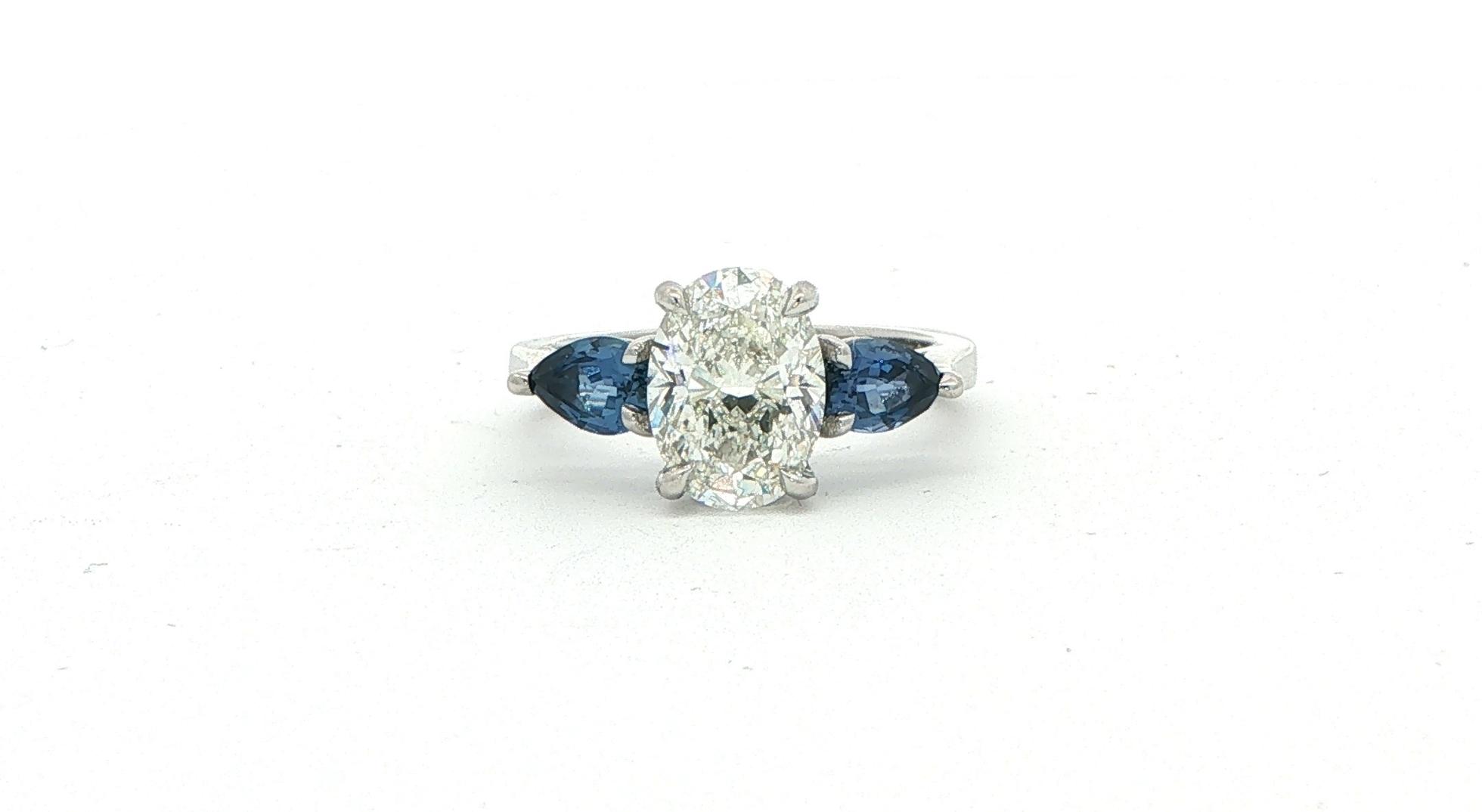 Oval Diamond and Pear Montana Yogo Sapphire Three-Stone Ring in Platinum (3.43cts TWT)