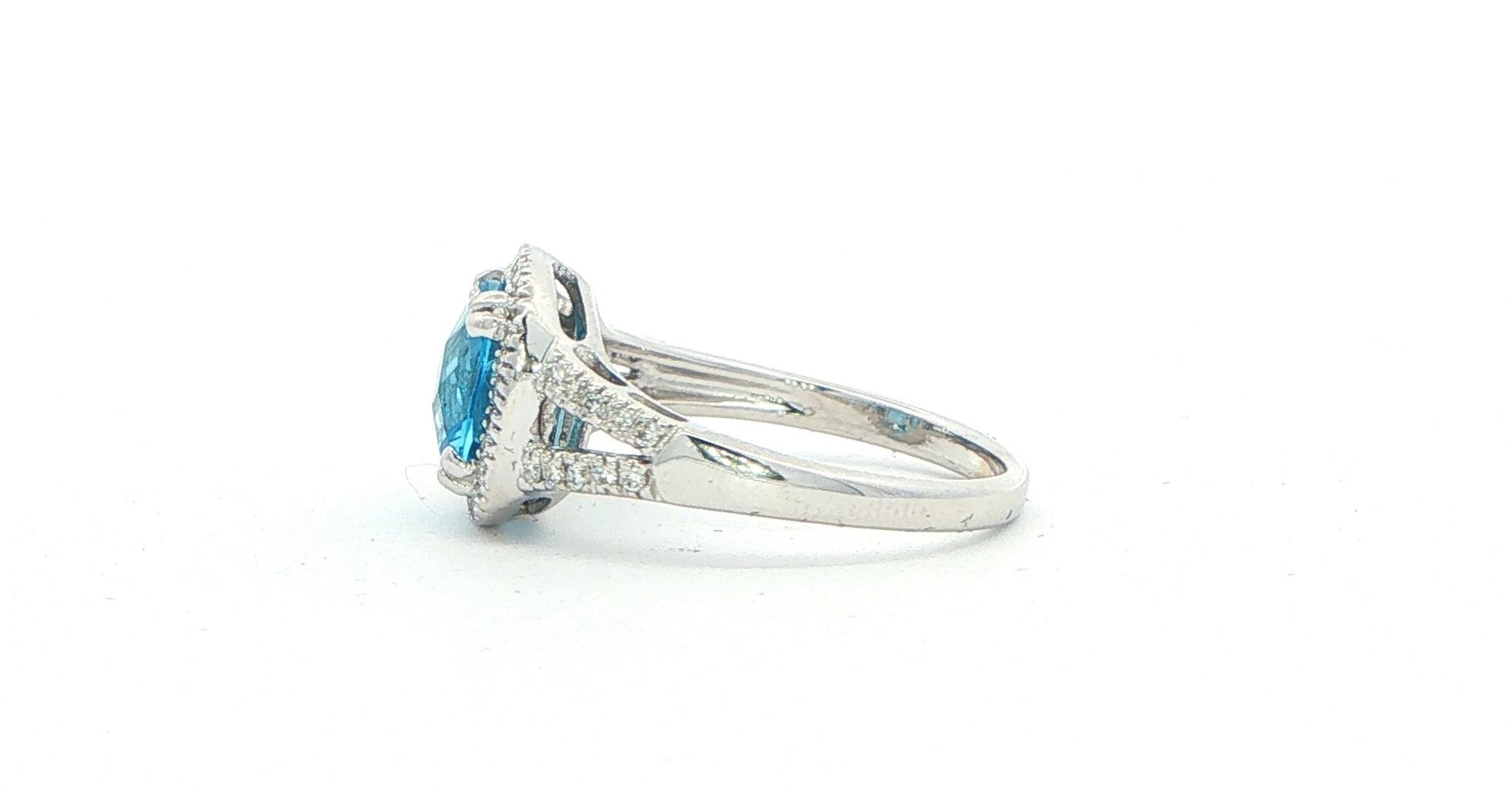 Estate Piece: Cushion Blue Topaz Split Shank Halo Ring in White Gold side