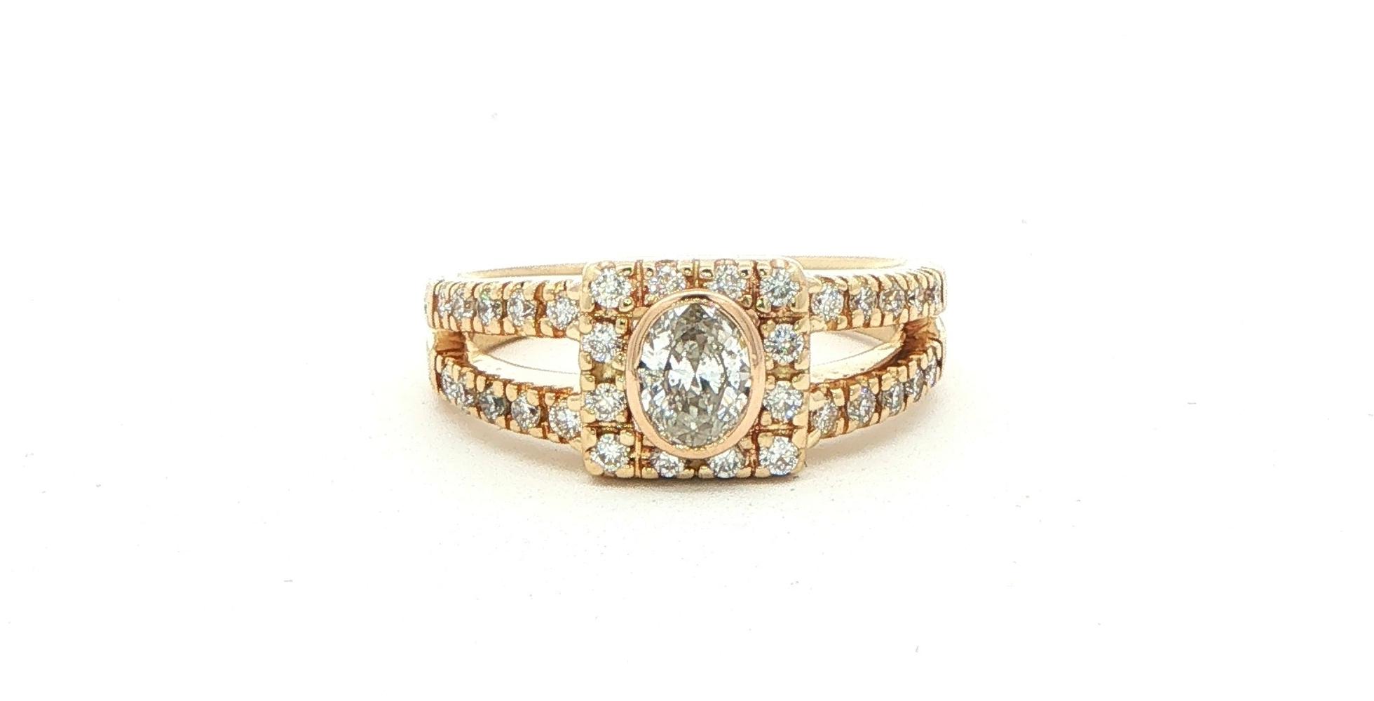 Estate Piece: Bezel-set Oval Diamond Halo Split Shank Engagement Ring in Yellow Gold (0.80cts TWT)