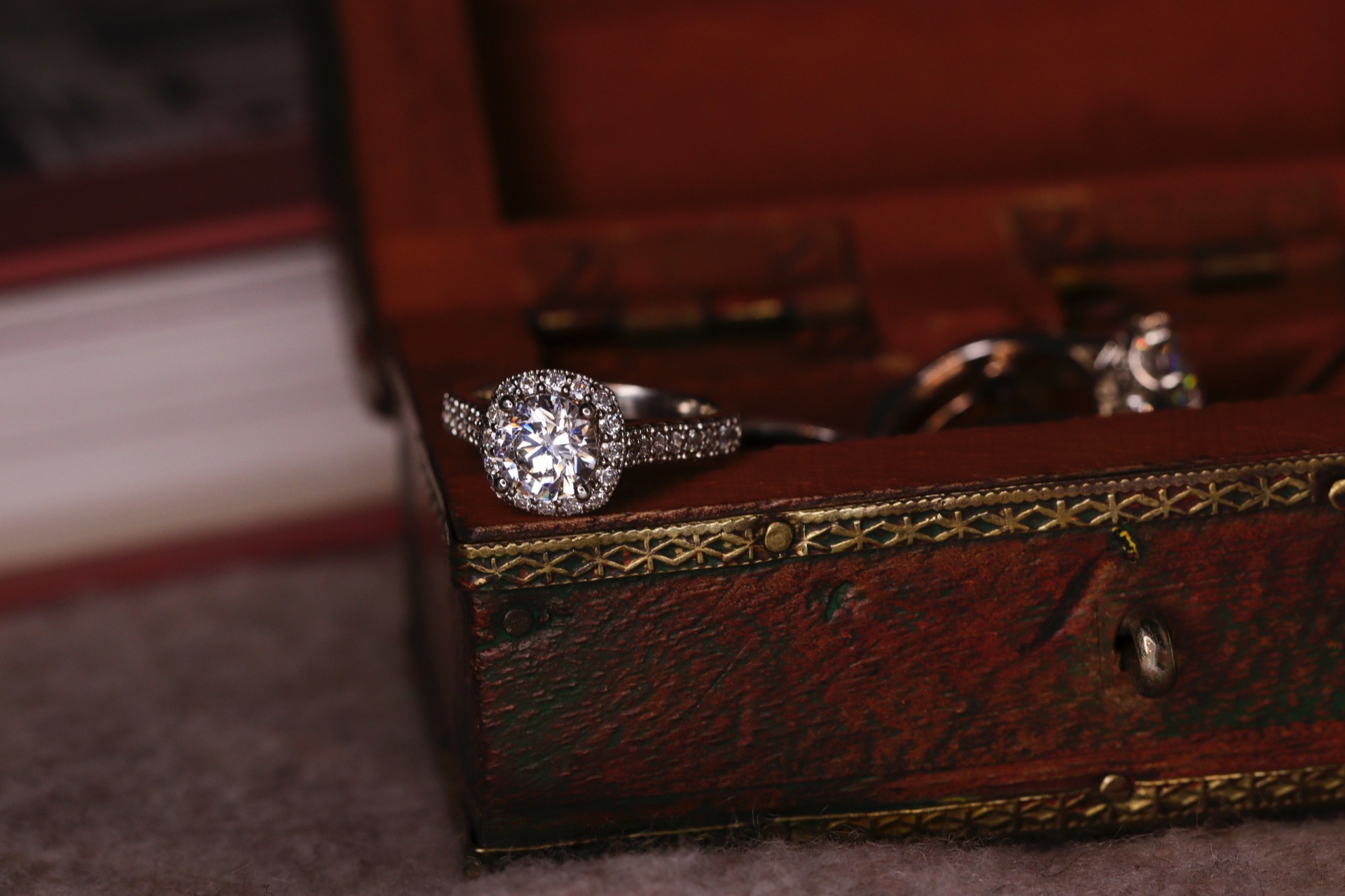 ring displayed on edge of small jewelry box